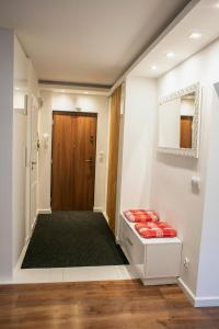 a hallway with a door and red pillows at Best Apartment in Tarnów