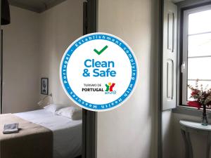 a sign that says clean and safe in a bedroom at Most Art Boutique Hostel in Leiria