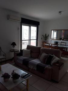 a living room with a couch and a table at Residencial Morada do Sol in Santa Maria