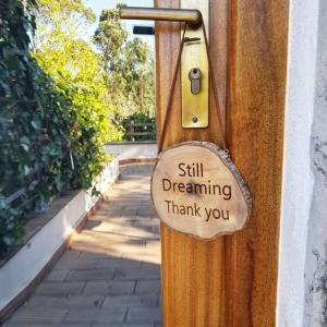 a sign on a door that saysstill dreaming thank you at Herdade Quinta Natura Turismo Rural in Aljezur