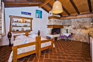 a bedroom with two beds and a fireplace at Apartments Villa Marcelina in Hvar