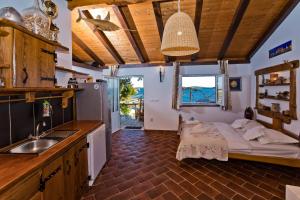 a kitchen with a bed and a sink in a room at Apartments Villa Marcelina in Hvar