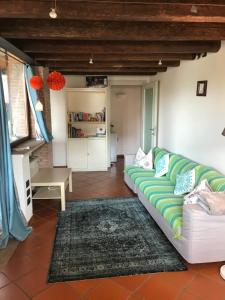 a living room with a couch and a table at Il Nido della Buonanotte 1 family friendly in Verona