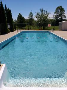 a large swimming pool with blue water at Wiarton Willys Inn in Wiarton