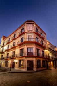 a large building with a clock on the side of it at Hotel San Diego in Guanajuato