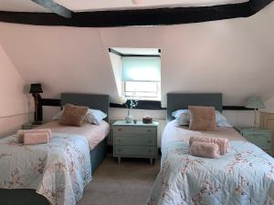 a bedroom with two beds and a window at Stylish 3 bedroom apartment in Upton upon Severn