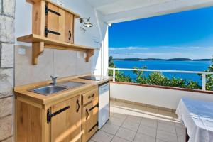 a kitchen with a sink and a view of the ocean at Apartments Villa Marcelina in Hvar