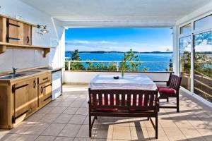 a kitchen with a table and a view of the water at Apartments Villa Marcelina in Hvar