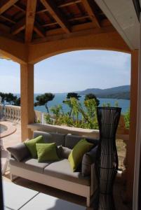 a couch sitting on a porch with a vase at PROPRIANO in Propriano