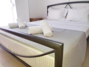 a bed with two white pillows on top of it at COZY & COOL Apartment N2 30m from sea in Nea Kallikrateia