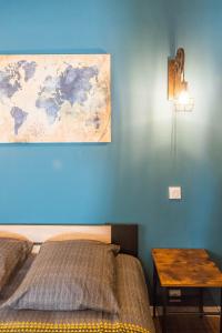 a bedroom with a bed and a table with a map on the wall at L'urbain Narbonnais in Narbonne +23 photos