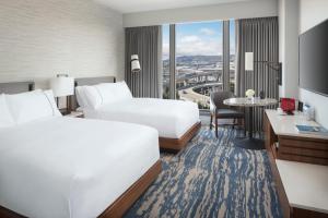 a hotel room with two beds and a table at Grand Hyatt at SFO in Millbrae