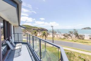 a balcony with a view of the ocean at Rosslyn Bay Resort Yeppoon in Yeppoon