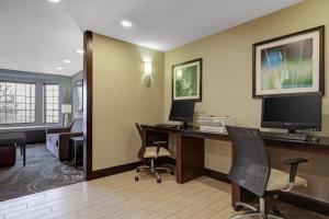 a hotel room with a desk with a computer at Staybridge Suites Washington D.C. - Greenbelt by IHG in Lanham