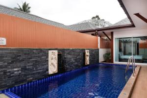 a swimming pool in front of a house at The Sun Pool Villa in Chaweng