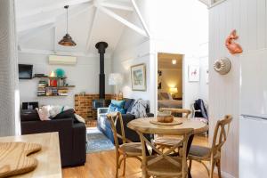 a living room with a table and chairs at Bandalong Cottages in Mudgee