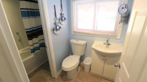 a bathroom with a toilet and a sink at Plovers Cove Cottage in Wasaga Beach +10 photos
