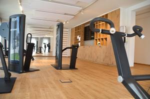 a gym with cardio equipment in a room at Hotel Hirsch in Neu-Ulm