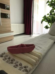 a bed with a red towel on top of it at Town Centre Flat in Blaj