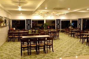 a dining room with tables and chairs in a restaurant at Buon Ma Thuot Hotel in Buon Ma Thuot