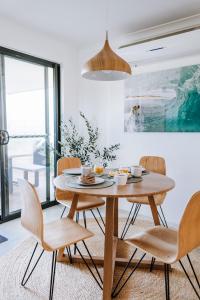 a dining room with a wooden table and chairs at 27 Degrees Kalbarri in Kalbarri