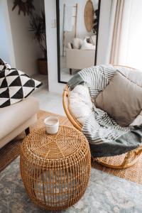 a living room with a chair and a table at 27 Degrees Kalbarri in Kalbarri