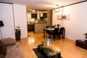 a living room with a couch and a table at Arpad Bridge Apartments in Budapest