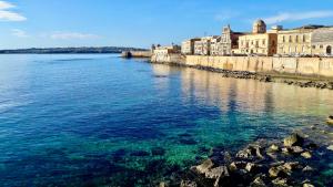 a view of a body of water with buildings at Elegante appartamento in palazzo storico Ortigia in Siracusa
