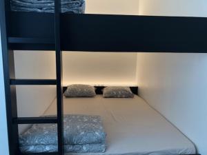 a bunk bed with two pillows on the bottom bunk at FLORIDE in Knokke-Heist