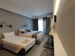 Postel nebo postele na pokoji v ubytování Minoa Hotel
