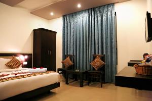 Voodi või voodid majutusasutuse Narayans Leela Inn toas