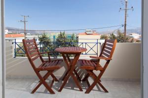 two chairs and a table on a balcony at Kontogoni Rooms in Elafonisos