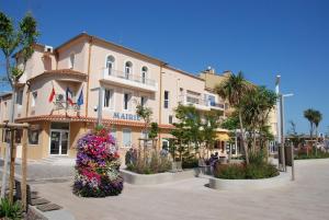 a large building with flowers in front of it at Appartement Belle Vue in Valras-Plage