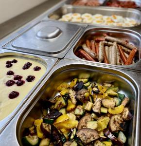 a metal pan filled with different types of food at Hotel Rustikal in Horní Cerekev