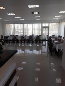 a dining room with tables and chairs in a building at pensiunea delta ideal in Sulina