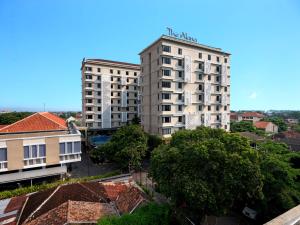 two tall buildings in a city with trees and buildings at The Alana Hotel & Conference Center Malioboro Yogyakarta by ASTON in Yogyakarta