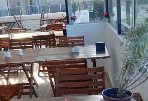 a patio with a wooden table and chairs at Saatlı Hotel in Çeşme