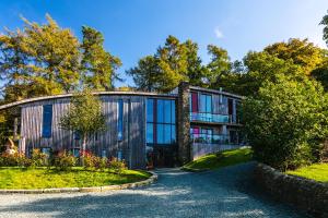 a house with glass windows and a driveway at Dome House in Bowness-on-Windermere