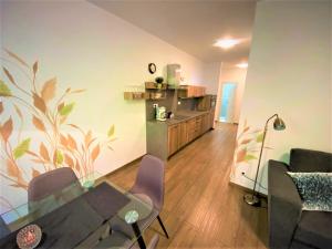 a living room with a glass table and chairs at Chopok Juh - Ambiente Apartment in Tale