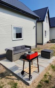 a barbecue grill on a picnic table in front of a house at Baltic Beach House in Rewal