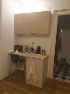 a kitchen with a counter with a microwave and a table at STUDIO TURQUOISE Victoria in Bucharest