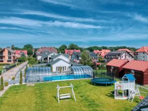 an aerial view of a backyard with a playground at Willa Perła Krynicy in Krynica Morska