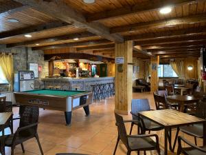 a pool table in a restaurant with tables and chairs at Hotel Romànic in Pla de l'Ermita