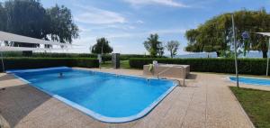 a large blue swimming pool in a yard at Balat-ON Apartman in Balatonberény