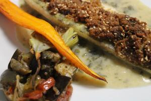 a sandwich with meat and vegetables on a white plate at Logis Hotel De Paris in Jaligny