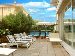 a group of chairs sitting on a patio at Hotel Ferrari in Salsomaggiore Terme
