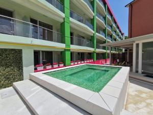 a swimming pool in front of a building at Hotel Fortuna in Eforie Nord