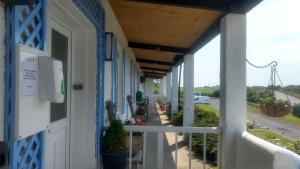 a porch of a house with a view of a street at Rhins of Galloway in Cairnryan