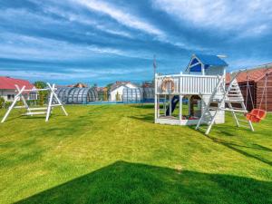 a group of playground equipment on a grass field at Willa Perła Krynicy in Krynica Morska