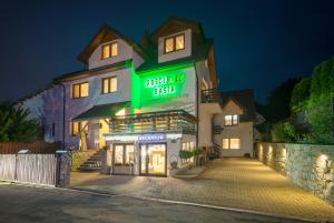 a building with a green sign on the side of it at Gościniec Basia in Kazimierz Dolny